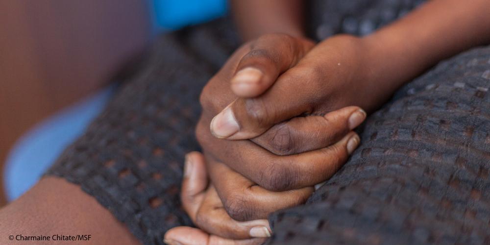 A women sits with her hands clasped in her lap. MSF, Doctors Without Borders, Safe Abortion care 
