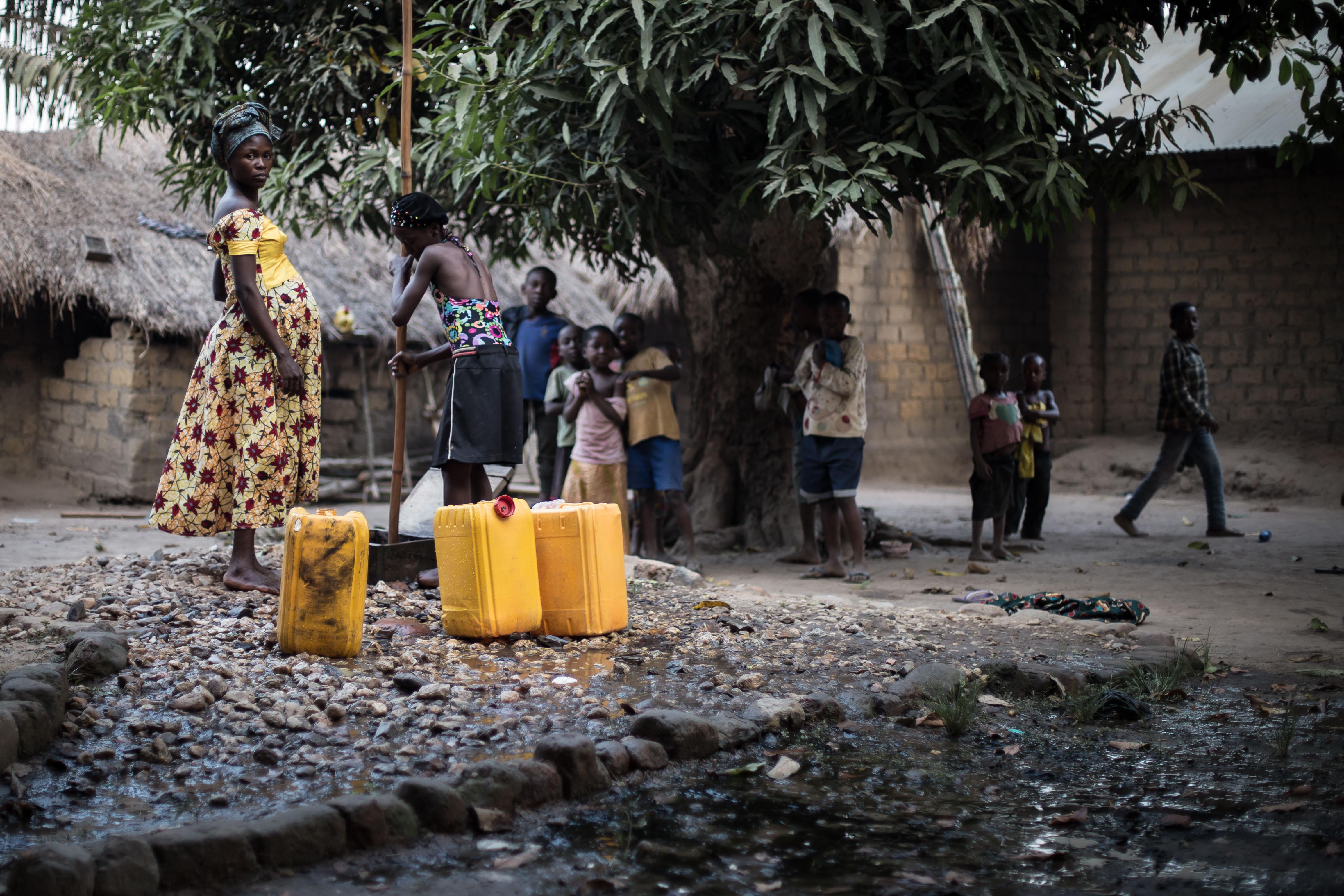 Women drawing water in Salambia, Democratic Republic of Congo
