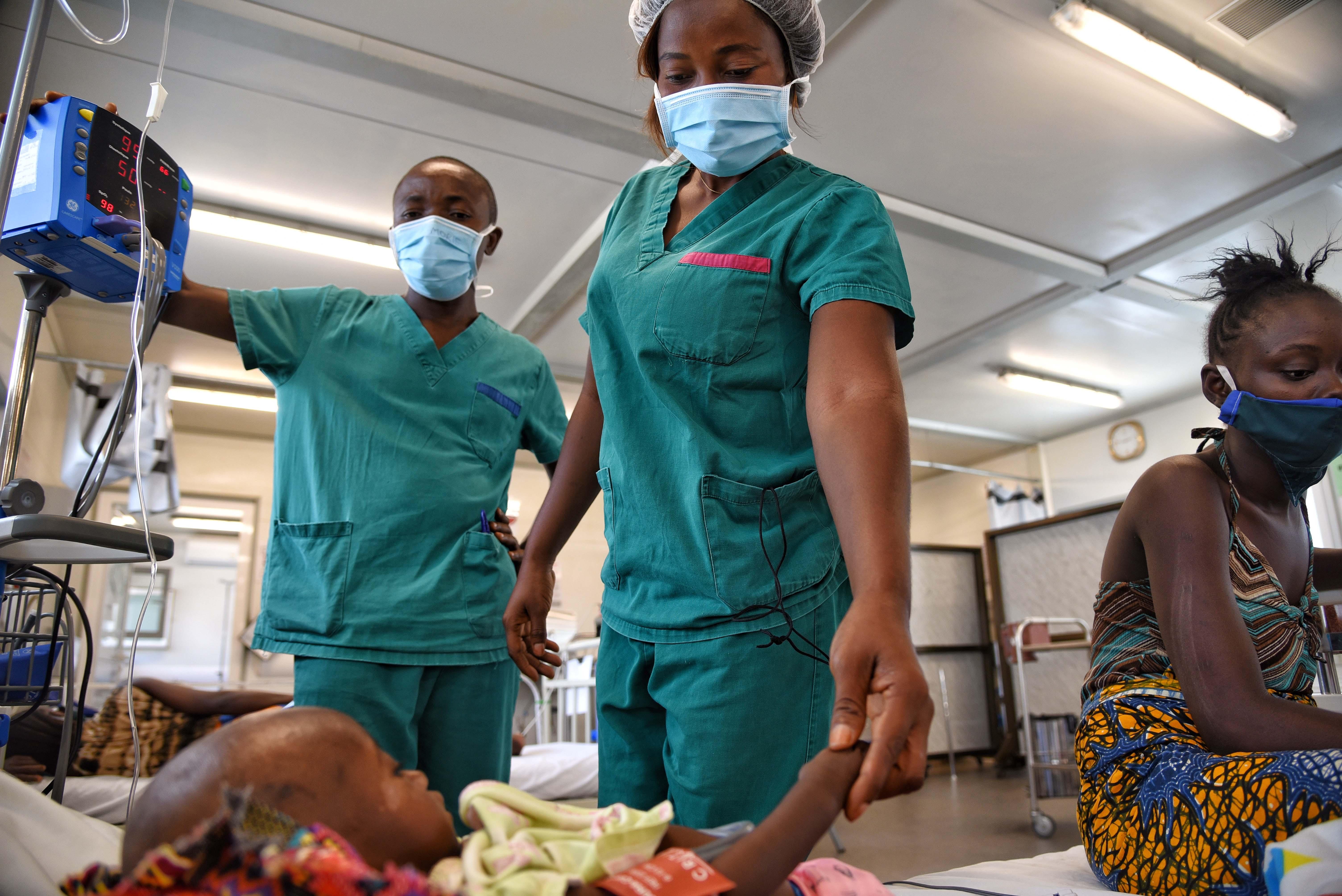 MSF nurse Ruth Gbassa checking on a baby in the intensive care unit at Hangha hospital in Kenema, Sierra Leone. 