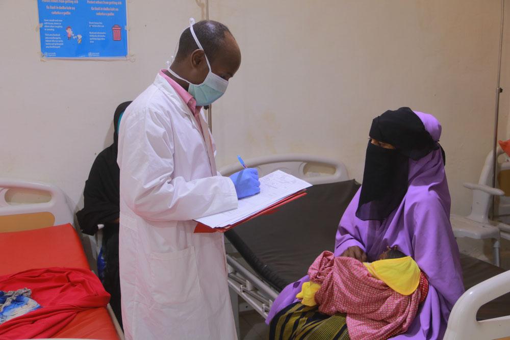 An MSF health worker checks the medical condition of a patient admitted to the inpatient therapeutic feeding centre in Galkayo South hospital, Galmudug state, Somalia.