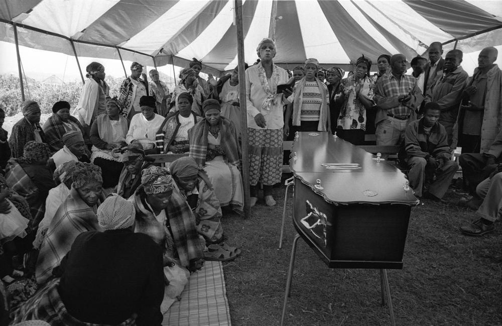 Family and friends at the funeral of an AIDS patient.