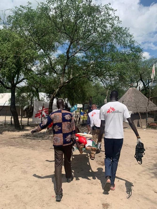 Patient being carried into Pieri Clinic