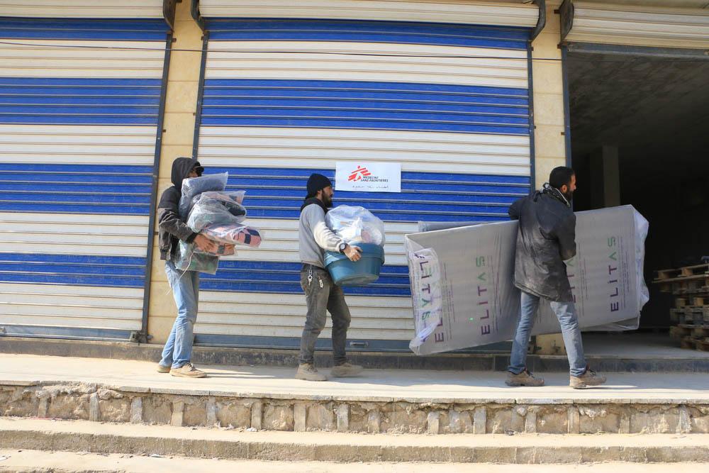 MSF team members loading trucks with necessities