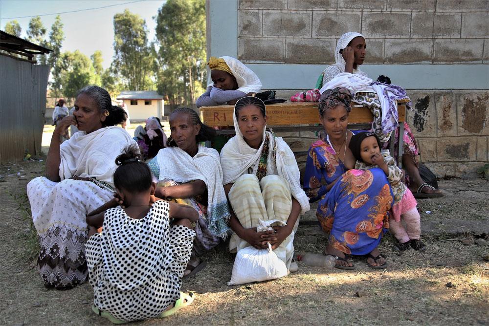 A picture of women sitting outside the Kundeya school in Axum, Tigray.