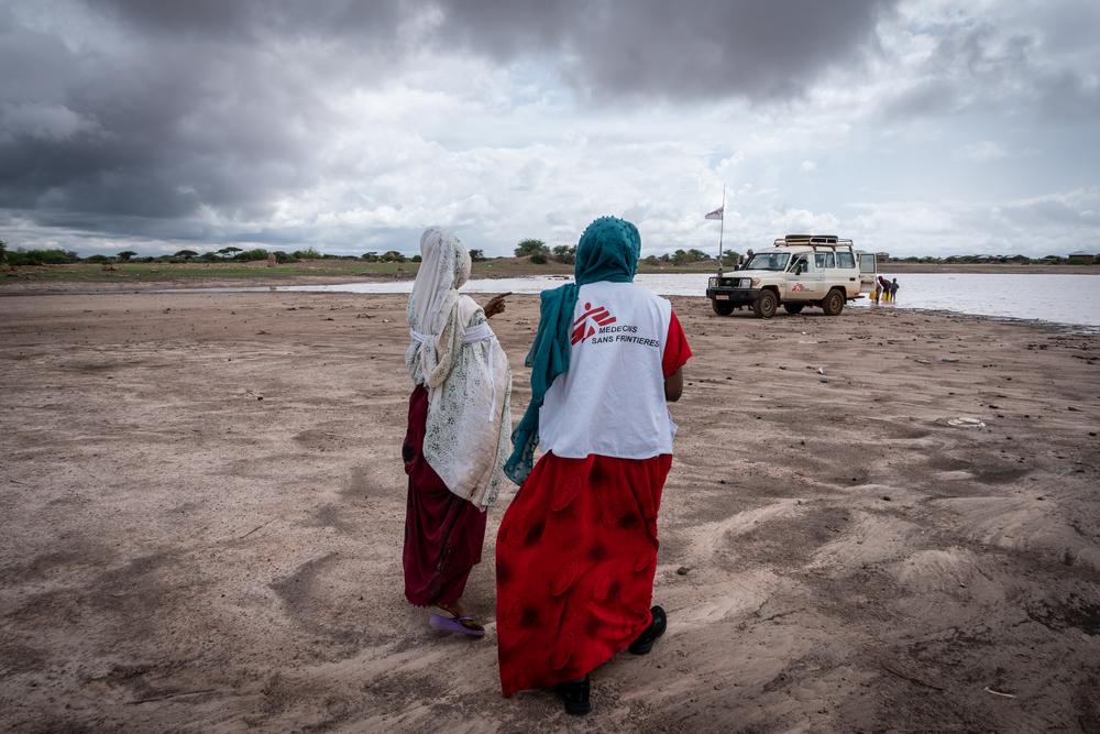 Village of Caado to collect muddy water for a health education session on water purification. Somali region, Ethiopia, March 2019.