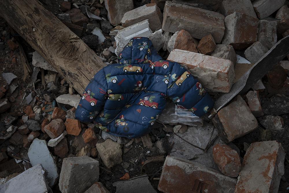A child's coat is in the rumble of houses destroyed by Russian bombings in Kharkiv, Ukraine, on April 10, 2022. 