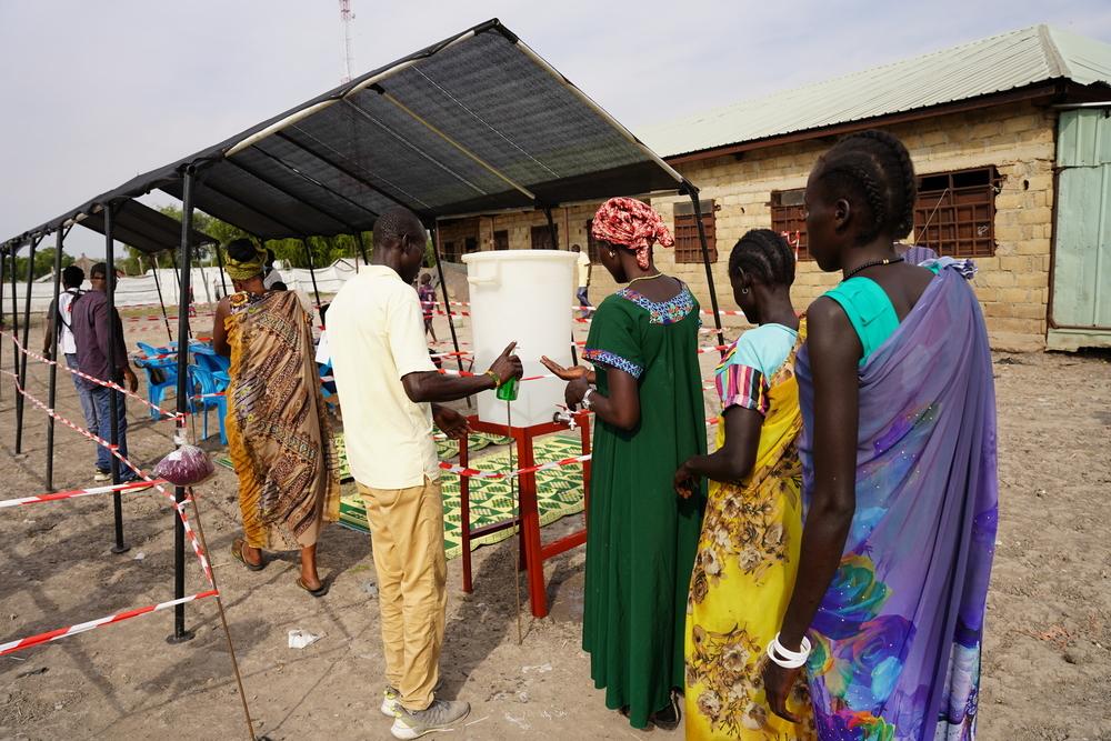 Women queue to receive hepatitis E vaccine in South Sudan