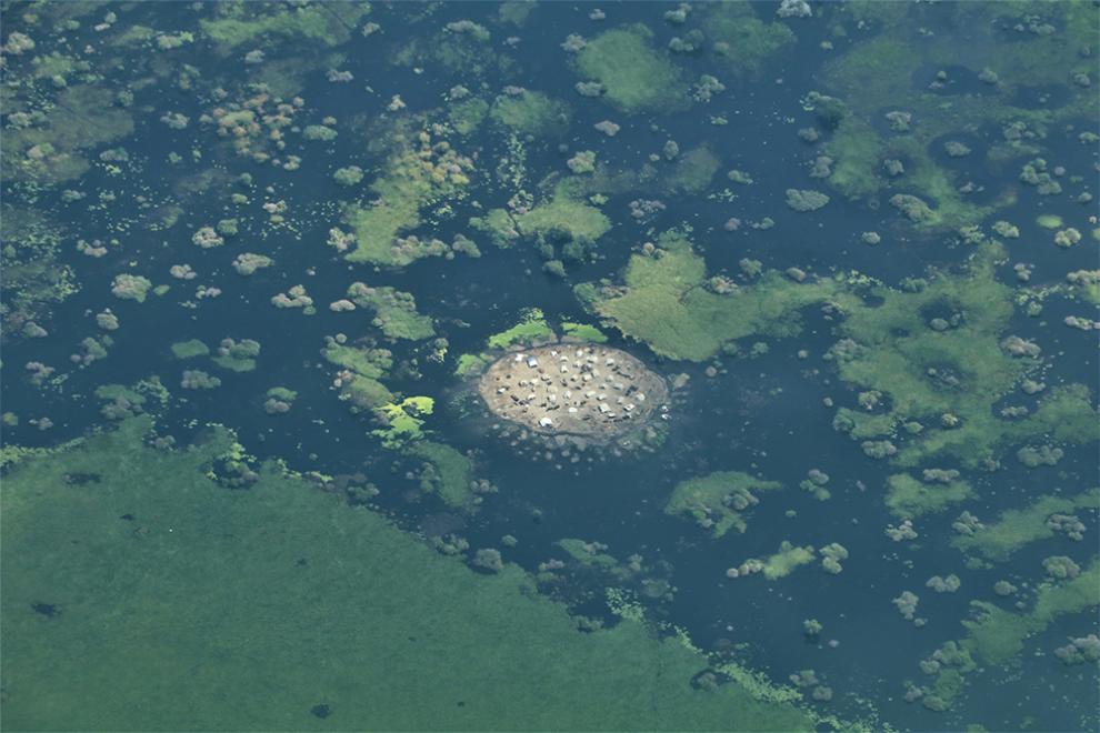 Houses sit surrounded by flood water in Jonglei State, South Sudan.