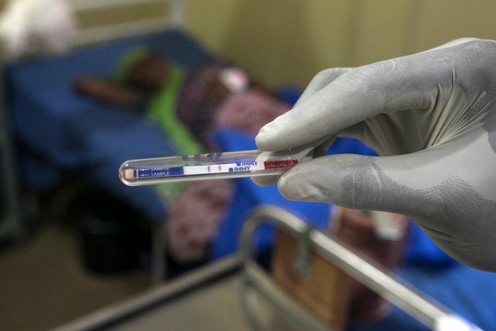 A gloved medical staff member looks at the results of a test. Antibiotic resistance is on the increase.