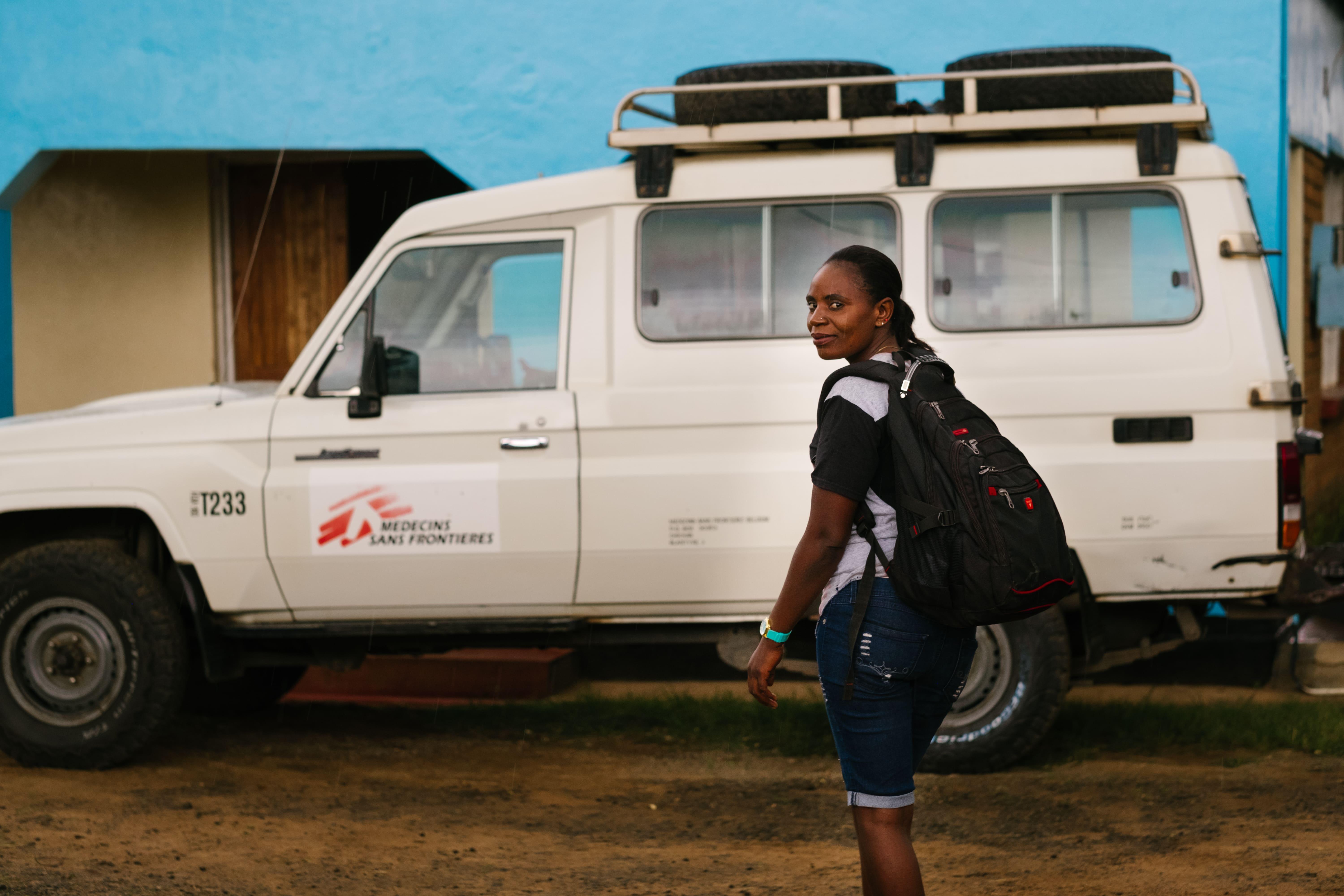 An image of our MSF community healthworker Alice Matambo carrying a backpack of health promotion tools