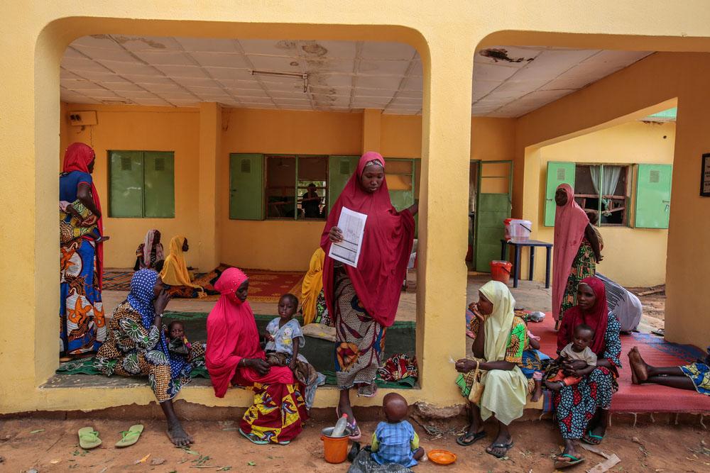 Mothers carry their children to be checked by MSF health workers