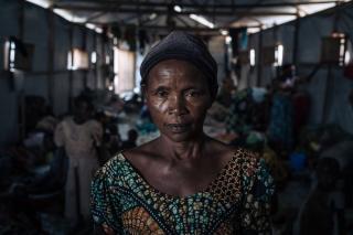 Agrippine, a 53-year-old displaced widow, poses for a photograph in a community shelter at the informal IDP site of Rugabo Stadium in Rutshuru Centre, in North Kivu province, eastern Democratic Republic of Congo. She and six of her ten children fled their village because of clashes between the Congolese army and the M23 armed group. She has no news of her other four children.