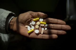 Simphiwe holds his medication, he takes up to 26 pills a day to treat XDR-TB. Here he holds his morning selection, which includes delamanid, one of the newest DR-TB drugs, which Simphiwe is taking for the first time today.