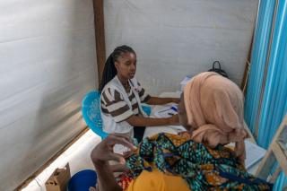MSF staff providing consultation with patient