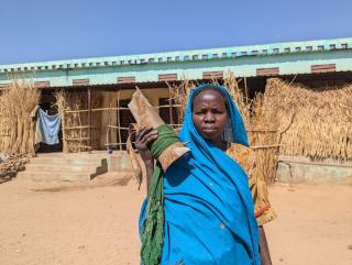 A woman in Darfur, Sudan. Holding a shelling.