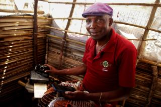 Maganja Vetu, 56, is from Muidumbe. Here he poses with his photography equipment at Nangua II, a resettlement