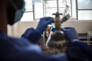 A patient receives care in the COVID-19 ward of Raqqa National Hospital, in northeast Syria. In the foreground, a nurse regulates the oxygen supply.