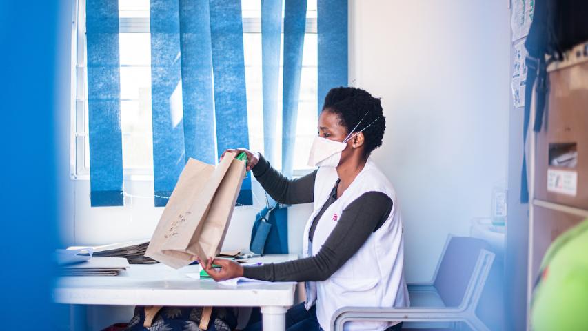 Pharmacy assistant bagging medicine