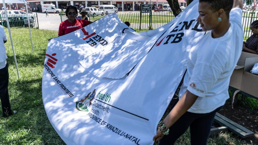 Our teams holding up TB awareness posters in Eshowe