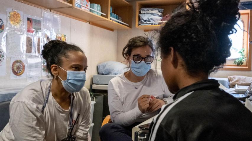MSF midwife Kira (left) and psychologist Graziana (middle) talk with Julia* during a medical consultation.