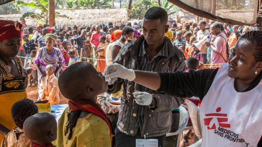 MSF Staff administrating an oral vaccine to a boy at the Nyaragusu refugee camp, Tanzania