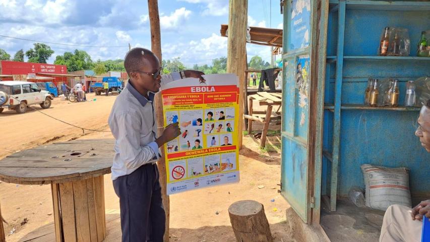 Doctors Without Borders (MSF) health promoter talks with a shop keeper in Madudu