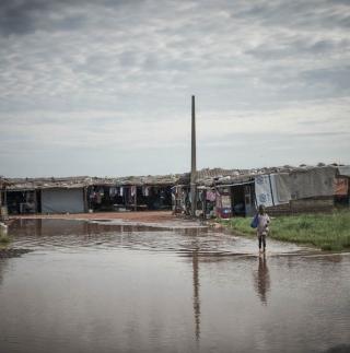 A child wades through water in the flooded Abyei Town, South Sudan
